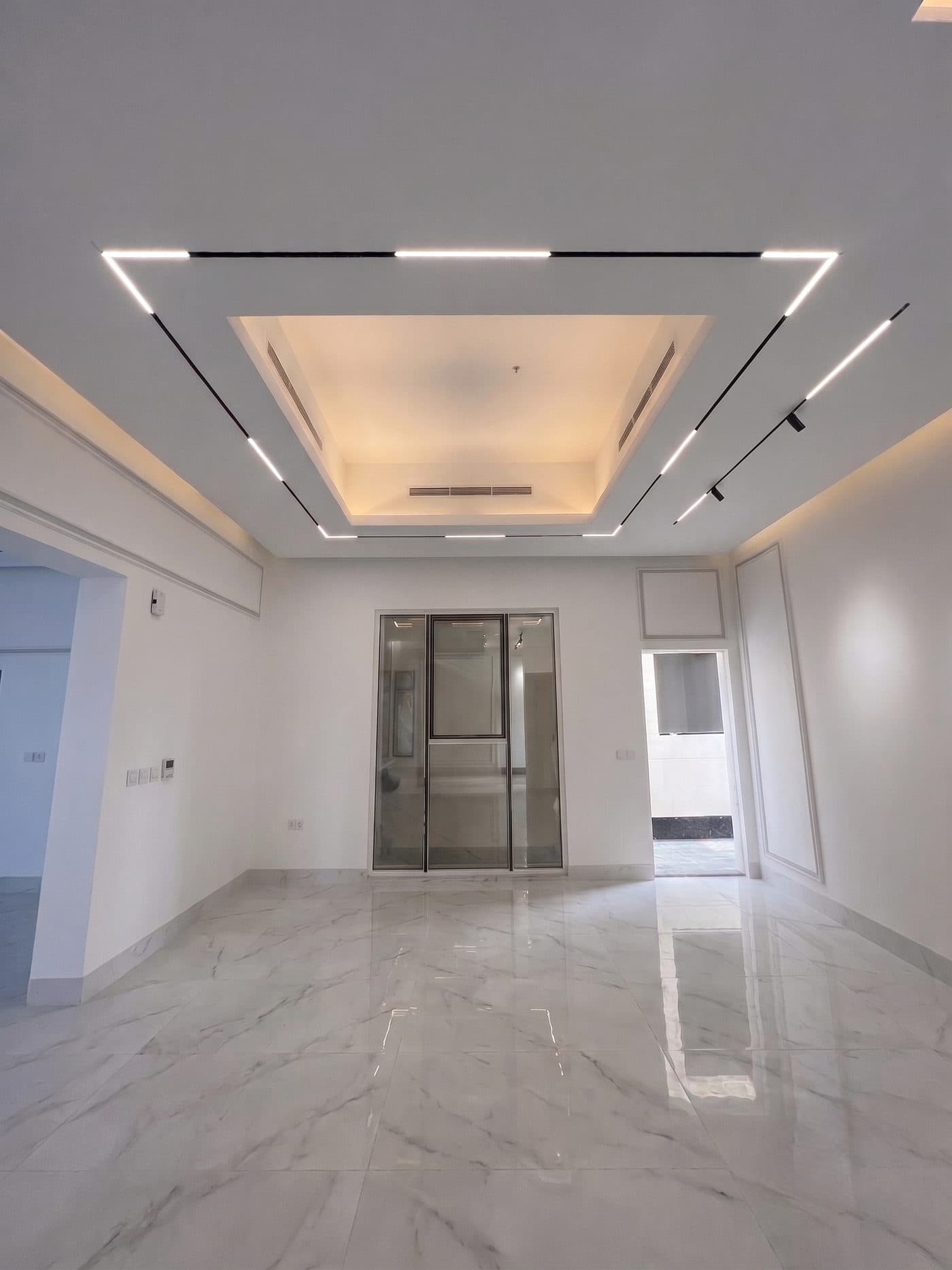 A reception room lined in book-matched marble.