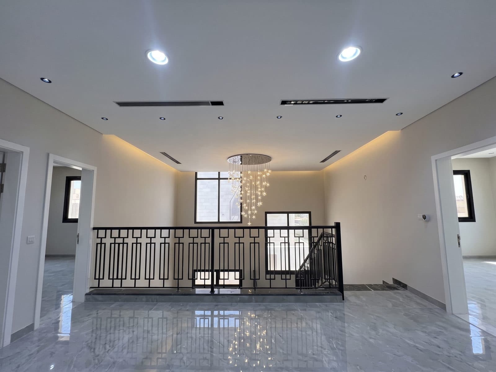 The upper landing and its geometric black steel balustrade