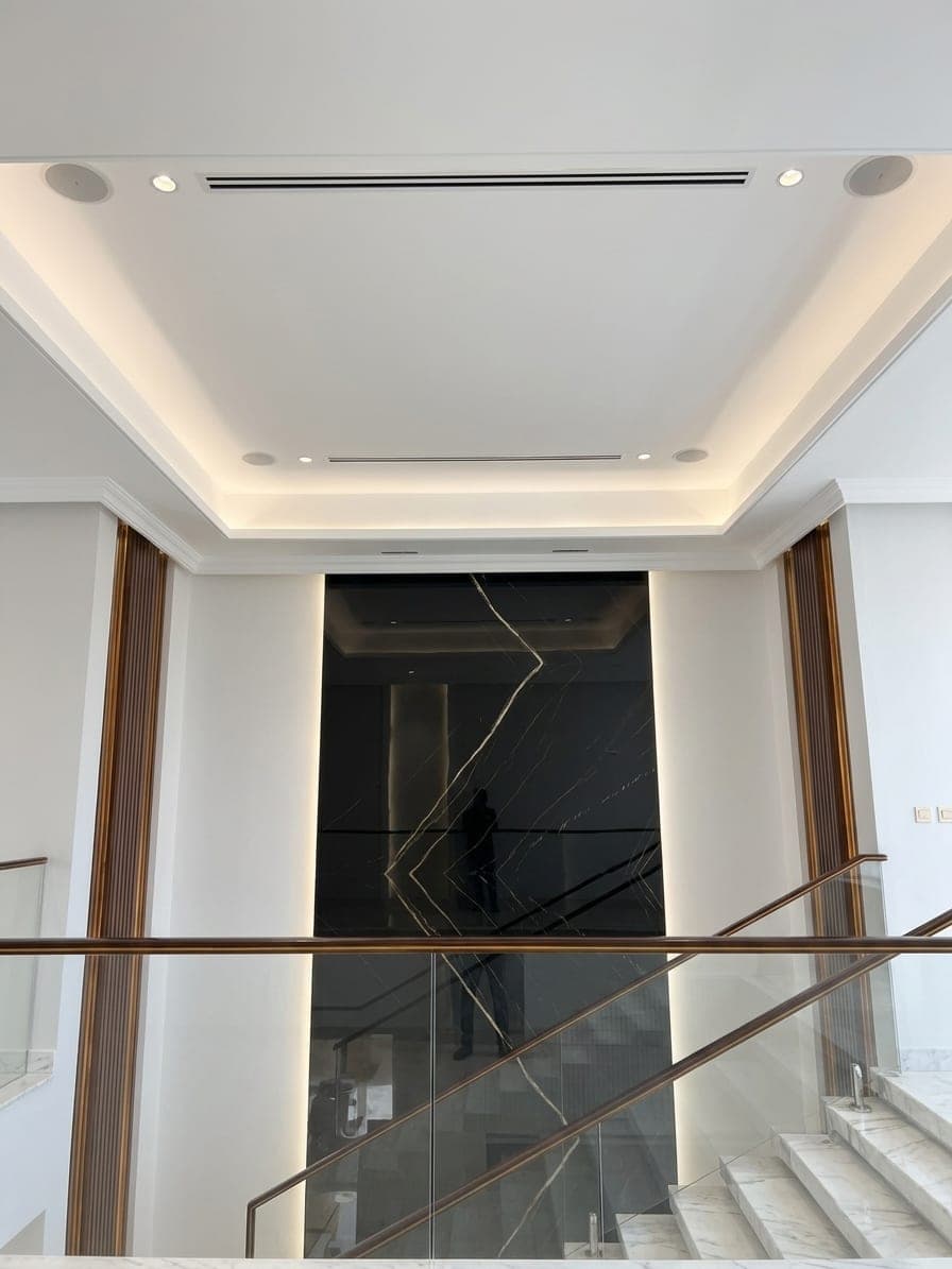 The double-height stair void with a glass balustrade