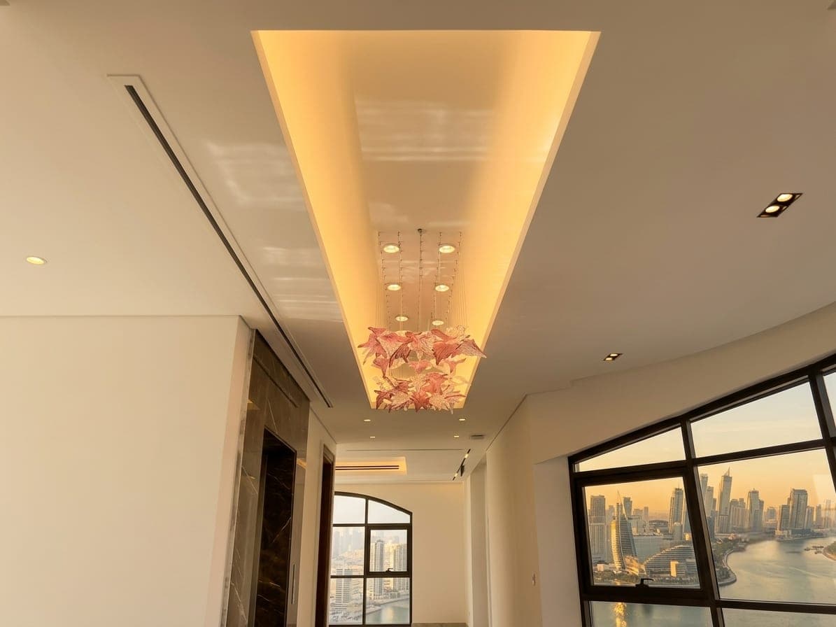A floating cove ceiling above a room open to the skyline