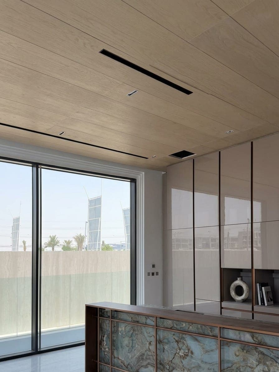 The quartzite island seen against full-height glazing