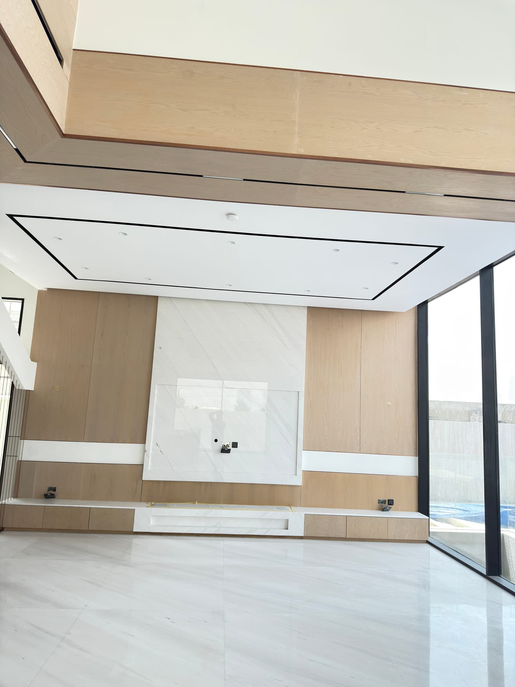 The book-matched marble feature wall across the reception space
