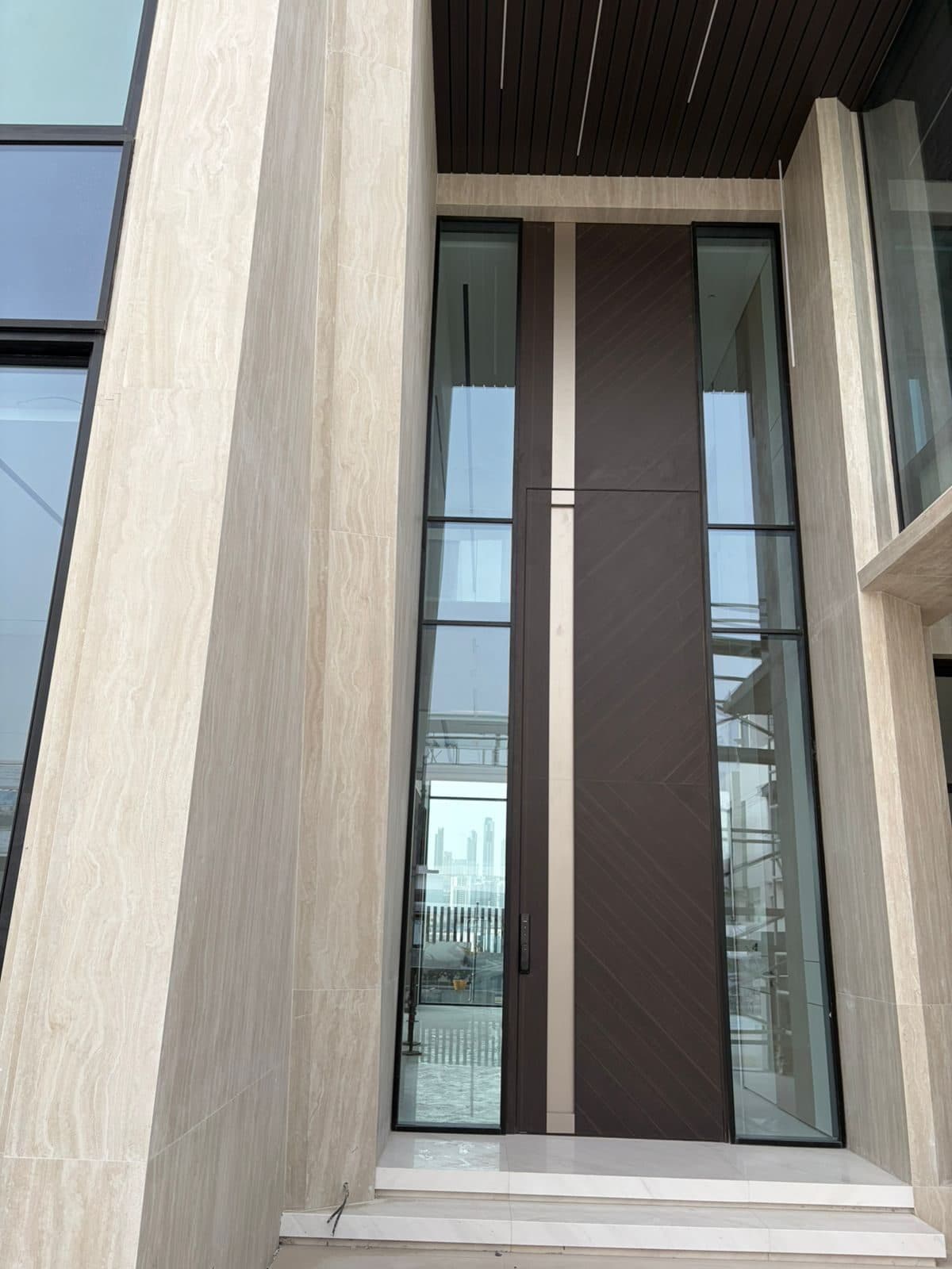 Close view of the pivot door's edge and ironmongery