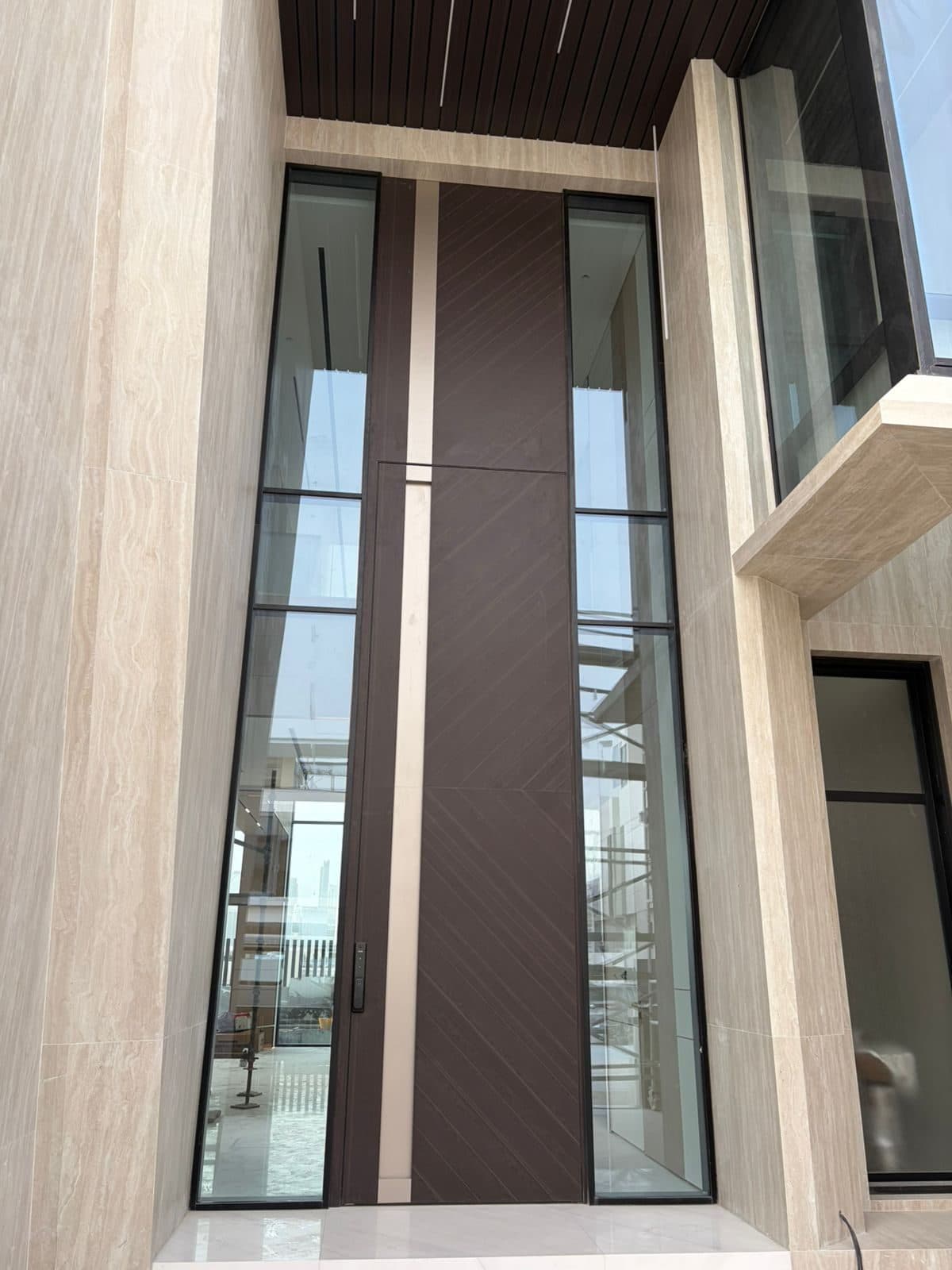 The pivot entrance door in its stone surround