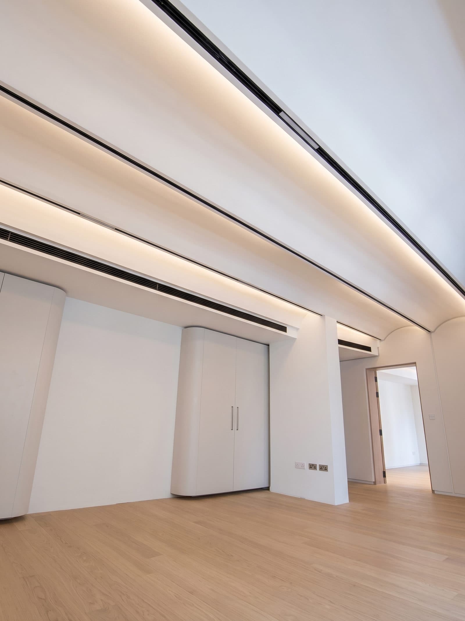 A room finished in timber flooring, looking toward the windows
